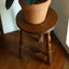Round wooden stool with decorative turned spindle legs