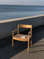 Solid wood chair with armrests in warm natural finish