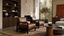 Modernist tan leather lounge chairs with slim black timber frames in an architectural living room with walnut shelving, stone walls and premium mid century furniture styling.