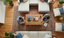 Living room where two people measure a rectangular wooden coffee table.