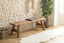 Sustainable furniture interior with natural timber, woven textures and eco-conscious premium materials in a warm modern home.