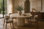 Francesca Natural Travertine Pedestal Round Table in a round dining tables interior, styled with espresso, cream and moss green, showing premium furniture scale and luxury design context.