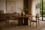 Michi Japanese Solid Wood Round Dining Table in a Japanese dining tables interior, styled with ink black, rice paper white and cedar, showing premium furniture scale and luxury design context.