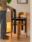 Terracotta and black minimalist wooden dining chairs on light wood floor