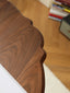 Cherry wood round table with turned pedestal on neutral rug