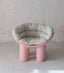 Pink chair with four-legged elephant-inspired design.