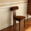 Modern Nanyang dining chair in wood and fabric.