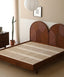 Wooden platform bed with dual circular rattan headboard panels