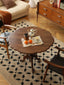 Cherry wood round table with turned pedestal on neutral rug
