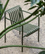 Maroon slatted iron armchair, ergonomic and versatile.
