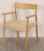 Solid wood chair with armrests in warm natural finish