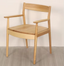 Solid wood chair with armrests in warm natural finish