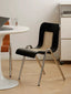 Solid wood and rattan chair with bold angular legs.