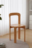 Terracotta and black minimalist wooden dining chairs on light wood floor