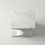 Marble-patterned square object on a light gray background top down view