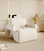 Modern white bouclé armchair with sculptural design.