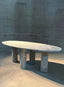 Modern dining table with unique marble veining and sturdy legs.