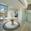 Modern living room with a round marble table and decorative elements.