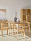 Black wooden dining chair with natural rattan seat