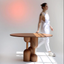 Round medium-toned wood dining table with sculptural base