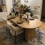 Oval light wood dining table with fluted legs