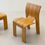 Sleek wooden chair with curved backrest.