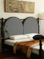 Black and white gingham headboard with double arches and dark wooden frame