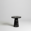 Black marble side table with white vein pattern on light gray background
