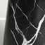 Close-up of black vase with white marble-like vein patterns on a plain background