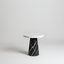 Conora pedestal side table with black marble base and white marble top on light gray background