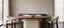 Luxury walnut and travertine oval dining table with ivory chairs in a refined Australian dining room