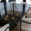 Close-up of Geo Square Nero Marquina marble dining table showing black stone top and white veining