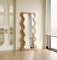 Full-length black mirror with dramatic wavy frame design