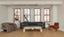 Gray curved armchair with cylindrical sides and plush upholstery