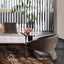 Black curved armchair with sculptural base