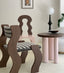  Retro-style wooden chair with wavy legs and black-and-white patterned upholstery
