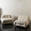 Pair of cream ribbed velvet lounge chairs with chrome accents
