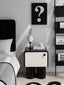 Modern black-and-white bedside table with sculptural legs.