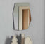 Tall asymmetric frameless mirror with angular design