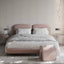 Blush wood and fabric bed with dual headboards in a modern setting.