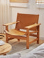 Saddle leather lounge chair with a solid wood frame.
