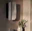 Tall asymmetric frameless mirror with angular design