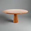 Dario round red travertine dining table