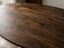 Close-up of the Serena dining table walnut oval tabletop showing rich grain, rounded edges and natural timber variation.