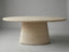 Aurelio Travertine oval dining table front view with sculptural pedestal base