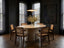 Aurelio Travertine oval dining table styled with cane dining chairs