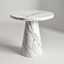 White marble side table with black vein pattern and conical base on a plain gray background