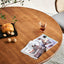 Minimalist wooden dining table with woven rattan chairs.