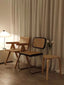 Stylish mid-century chair with woven rattan backrest.