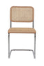 Natural rattan dining chair with sleek metal frame.